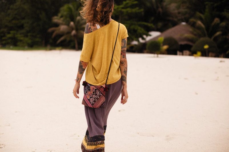 Woman walking wearing a sling bag